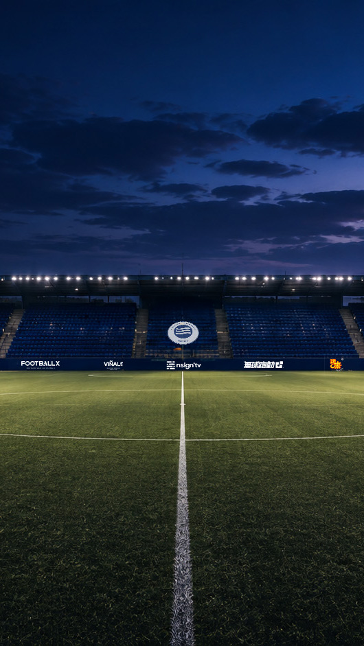 Inter Barcelona stadium at blue hour, floodlights on